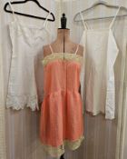 Vintage lingerie and nightwear, an orange satin slip with lace detail and pink ribbon straps, a