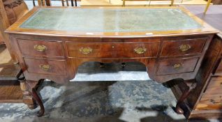 Early 20th century walnut bowfronted writing table/dressing table in the Queen Anne manner, the