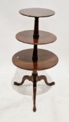 19th century mahogany dumb waiter of circular graduated form, on turned tapered supports and three