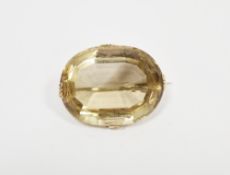 Citrine and yellow metal brooch, the oval cut stone claw set, 4cm x 3cm approx.