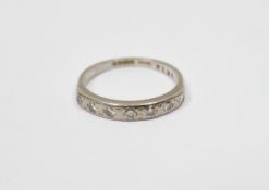 18ct gold and diamond half-eternity ring set seven diamonds in rubover setting, 3.7g total