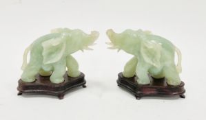 Pair of Chinese carved jadeite elephants, 20th century, each modelled standing four-square with