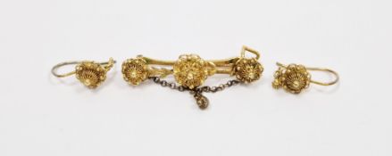 Continental yellow metal bar brooch with three raised filigree and ball rosettes and matching pair