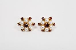 Pair of 9ct yellow gold, pearl and garnet stud earrings, each comprising a central claw set garnet