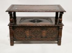 Early 20th century oak monk's bench, the rectangular top with foliate scroll carved border and