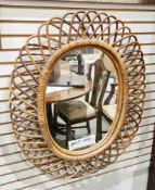 Retro-style wicker framed wall mirror, of oval form, 79cm x 65cm together with a wooden carved