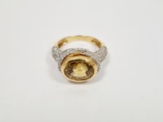 18ct yellow gold lady's dress ring set with an oval citrine, surrounded by small diamonds, gross