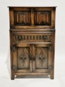 Early to mid-20th century oak cocktail cabinet in the Jacobean manner, the upper section with hinged