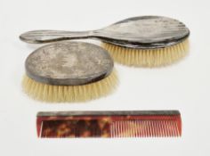 Two early 20th century silver backed dressing table brushes, one engine turned and the other
