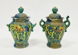 Pair of Japanese late Meiji period (1868-1912) green ground pottery vases and covers, each with