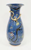 Late 19th century Chinese porcelain baluster blue ground vase, moulded with a scrolling dragon