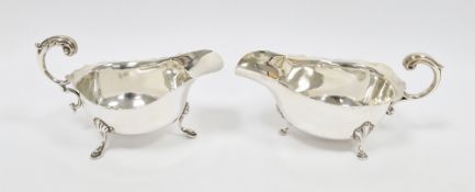 Two Georgian-style silver sauceboats, each with shaped rim, with pad feet and shell terminals,