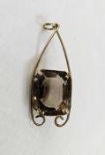 Gold-coloured metal and smoky quartz pendant, the rounded rectangular cut stone claw set within