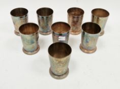 Set of eight Mappin & Webb silver plated beakers, each of tapered form with floral and foliate