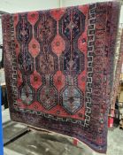Eastern red ground rug with geometric lozenge pattern field with flowers, multiple geometric borders