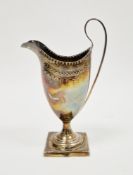George III silver helmet-shaped cream jug with bright cutting and hammered decoration, engraved with