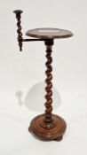 Early 20th century oak stand/side table, the circular top with ogee moulded edge on a barleytwist