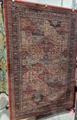 Large red ground John Lewis wool rug with floral trelliswork, multiple geometric and floral borders,