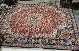 Large red ground carpet with central floral medallion, floral field with hanging baskets, floral