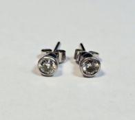 Pair 18K white gold and diamond solitaire earrings, collet-set, each approx. 0.25ct