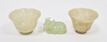 Two Chinese carved pale jade cups, each of flared footed form, 2.3cm high x 5.7cm diameter (some