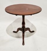 George III mahogany supper table, the circular tilt-top on a turned baluster support with three