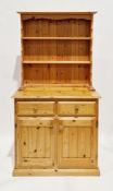 Modern pine dresser, the top with two plate shelves on a base with two drawers over two cupboard