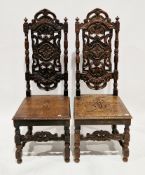 Pair of Victorian oak hall chairs in the 17th century manner, the backs carved with foliate scrolls,