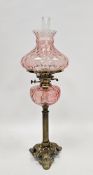 Victorian oil lamp having pink tinted moulded glass shade and well, clear glass chimney and brass