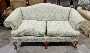 Sofa in the George III manner, having camel back and scrolling arms, upholstered in a green and