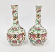 Pair 19th century Chinese porcelain clobbered Canton decorated bottle vases, each painted in