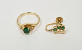 14k yellow gold emerald and diamond cross-over ring, comprising a central claw set mixed cut oval