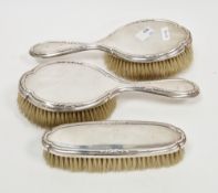 George V silver-backed three-piece dressing table set, London 1916, Mappin & Webb, the shaped