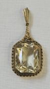 Gold-coloured metal and citrine-coloured pendant, the shaped rectangular cut stone in beaded and