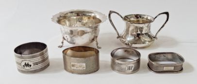 Small silver sugar basin with two handles, a small silver sugar basin with serpentine edge, on three