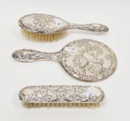 Elizabeth II three-piece silver-backed Victorian-style dressing table set, decorated in repousse