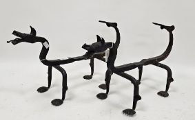 Pair of hand-forged iron firedogs in the form of Chinese dragons, with forked tails and paw feet,