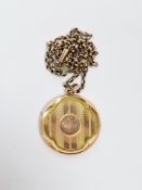 Early 20th century 9ct yellow gold locket of round form with engine turned engraving and cartouche