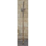 Replica halberd with metal spike and pierced blade, the wooden handle with part metal studded