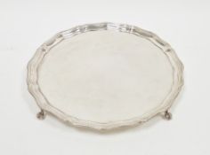 Silver salver, circular with ogee serpentine border, beaded edges, raised on four claw and ball