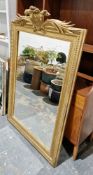 19th century giltwood and gesso pier glass, having foliate and scroll cresting atop frame with