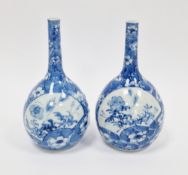 Pair of Chinese porcelain blue and white bottle-shaped vases, early 20th century, painted with loose
