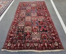 Large Iranian red ground carpet with floral design trelliswork, multiple herati and floral borders