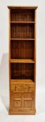 Modern stained pine wall unit comprising four graduated shelves over a single drawer and a