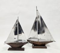 Two polished aluminium and wooden models of sailing boats or yachts, in the Art Deco style.