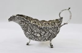 S Kirk & Son American silver-coloured metal sauceboat, having foliate scroll handle, the body