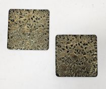 Pair of Persian brass square plaques cast in relief with lions and birds amongst foliage, 15cm x