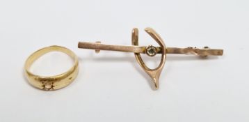 9ct gold wishbone bar brooch with white stone and a gold-coloured metal and diamond ring, the