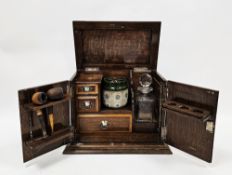Early 20th century oak smoker's cabinet, the two panel doors opening to an interior fitted with