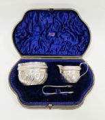 Victorian cased matched silver sugar bowl, cream jug and sugar tongs set, the sugar bowl Chester